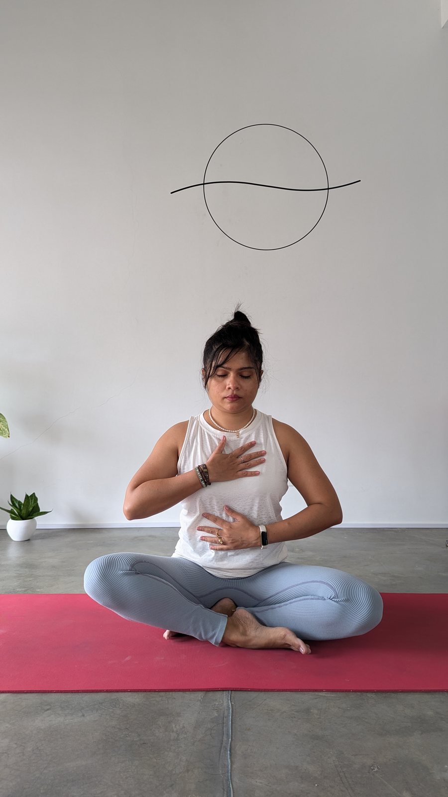 A woman practising quiet breathwork at Svastha Studio, where meditation sessions take place